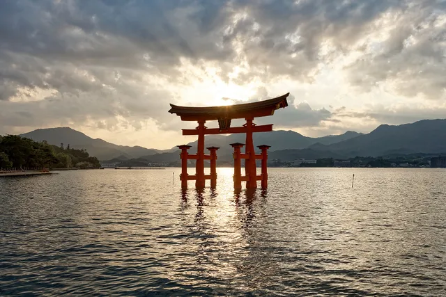 The great red floating torii gate of Itsukushima Shrine on Miyajima island standing in the sea at high tide